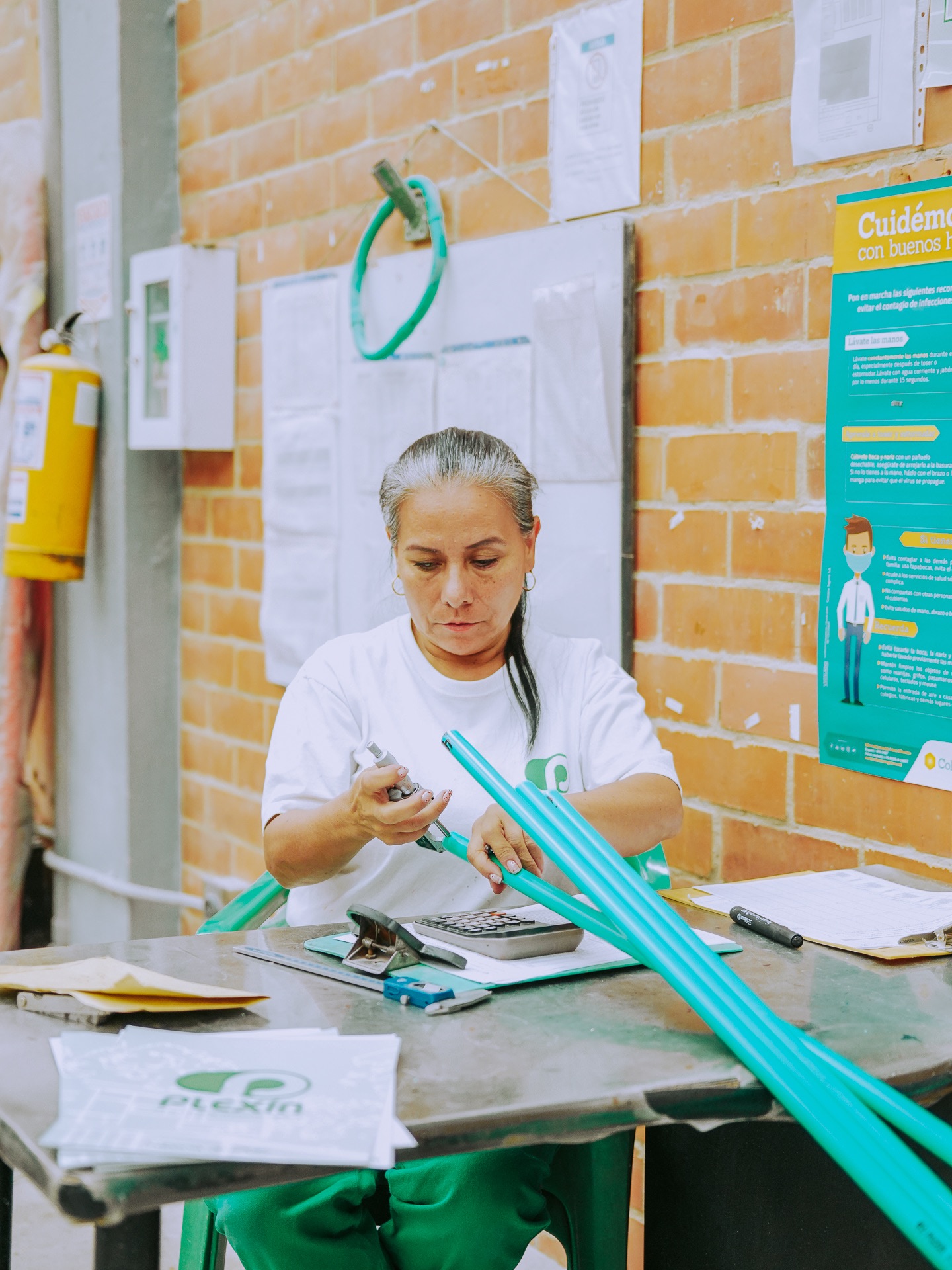 Mujer trabajando en fabrica de tubos PVC